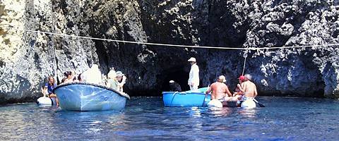 'Guarding' the entrance to the Blue Cave on Bisevo, a lady (in the small blue boat with her dog) collects tickets from tourists as they enter the cave. Photo © 2003 Keith Bramich