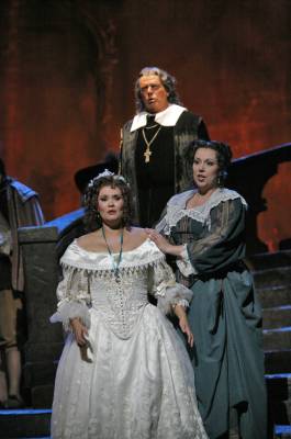 Soprano Angela Gilbert (Lucia) is flanked by soprano Kathleen Halm (Alisa) while bass Reinhard Hagen (Raimondo) looks on, in San Diego Opera's 'Lucia di Lammermoor'. Photo © 2006 Ken Howard