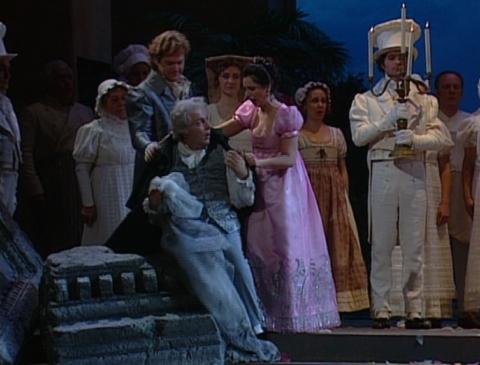 Ernesto (Gregory Kunde) with Don Pasquale (Ferruccio Furlanetto), Norina (Nuccia Focile) and members of the chorus during the closing moments of the opera. Screenshot © 1994 RAI Trade 